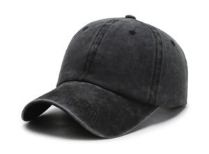 Solid black faded washed cotton baseball cap, soft unstructured low crown, curved UV protection brim, air vent holes plain white studio background
