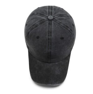 Dark grey faded washed cotton baseball cap overhead flat shot, central fabric top button, side air vent holes matte washed cotton texture