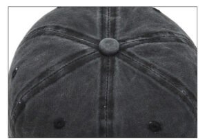 Distressed black washed cotton baseball cap, six-piece stitching crown, central fabric top button, round breathable air vents studio detail photo