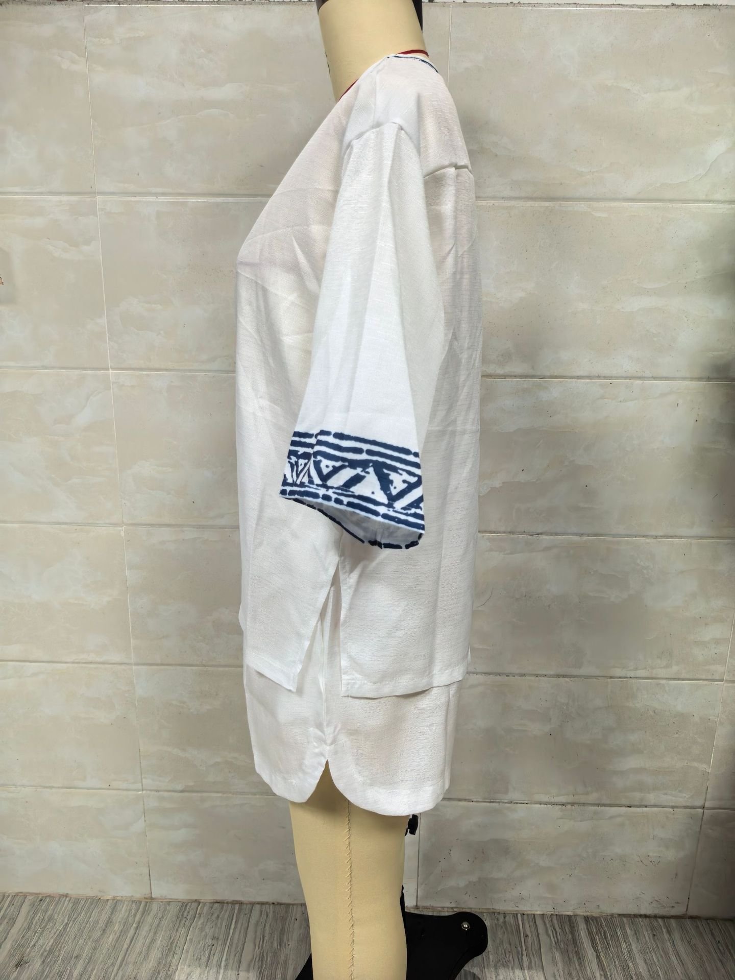 Actual side view of white Bohemian embroidered V-neck linen shorts set