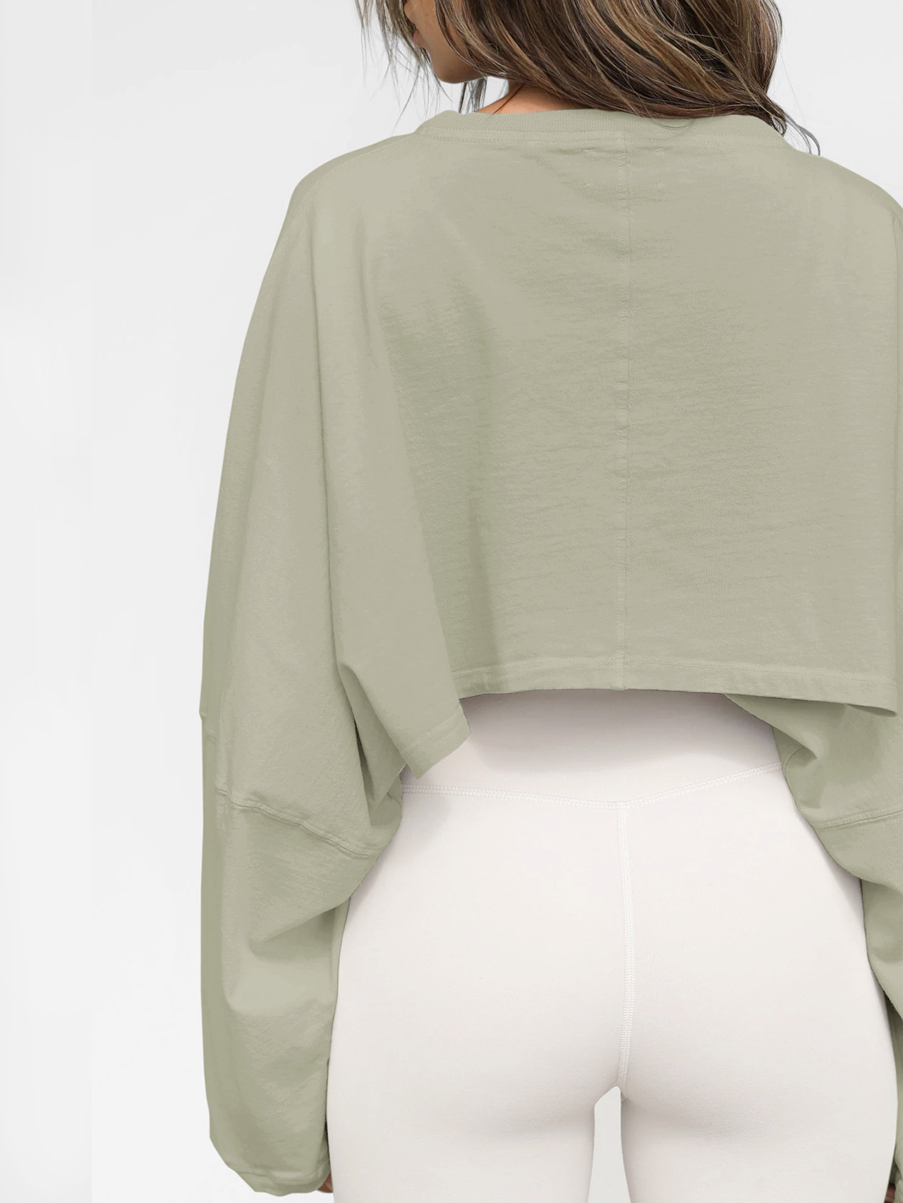 Light Green Cropped Sweatshirt - Back Detail View Back view of womens light green oversized cropped sweatshirt, showing center back seam and fabric texture, vintage wash finish, paired with white high-waisted leggings
