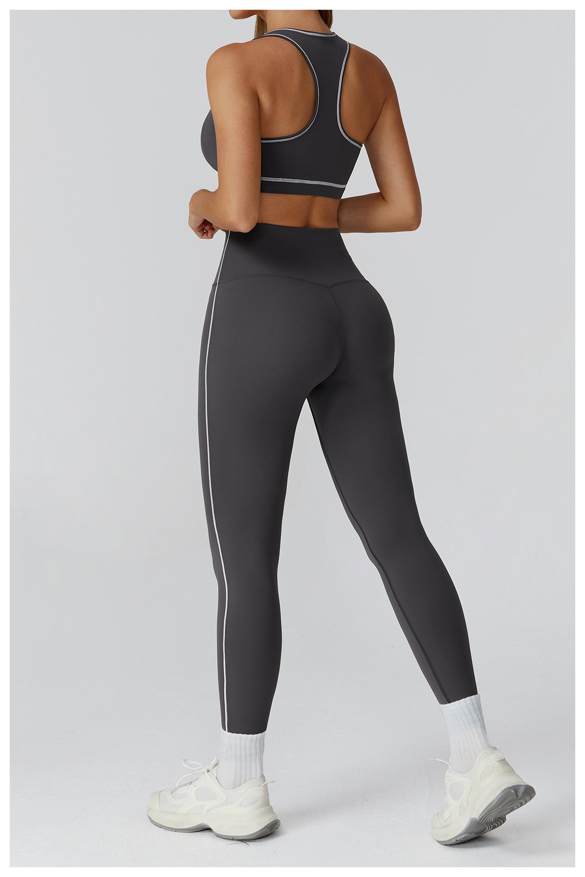 Model image behind dark gray sports vest yoga pants