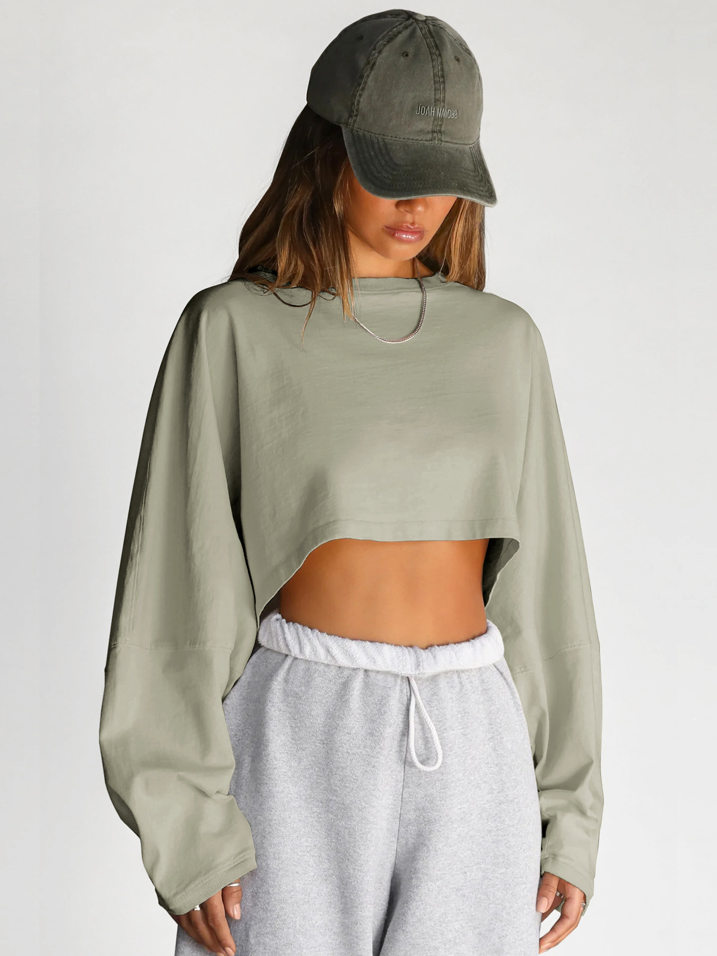 Light Green Oversized Cropped Sweatshirt - Front Straight View Womens light green oversized cropped sweatshirt, loose fit long sleeve pullover, vintage pigment dyed loungewear, front straight view on model