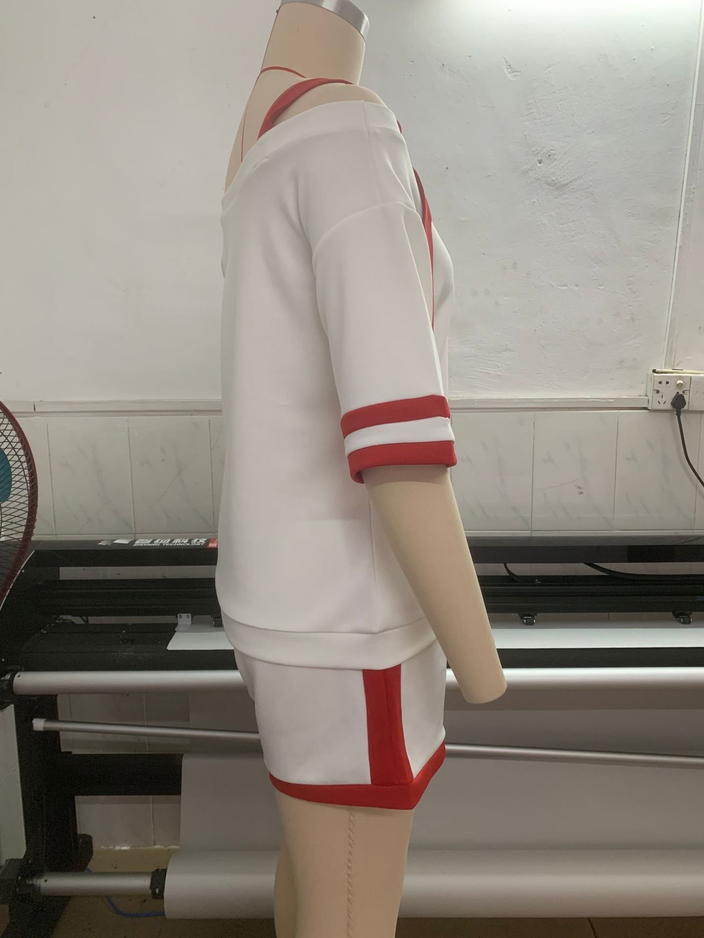 Side view white off shoulder color trim short tracksuit set, loose half sleeve red stripe cuffs red trim short hem elastic drawstring waist casual two piece suit