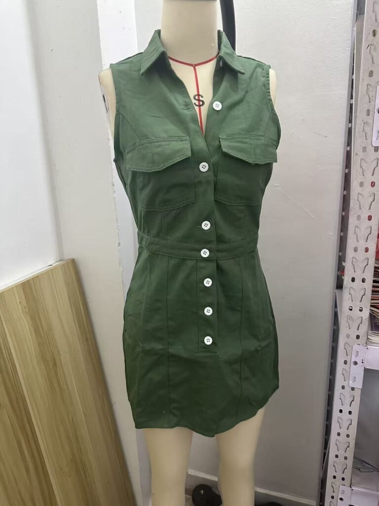 Dark green sleeveless denim mini dress mannequin display front view, full button down double chest pocket lapel collar casual denim mini dress