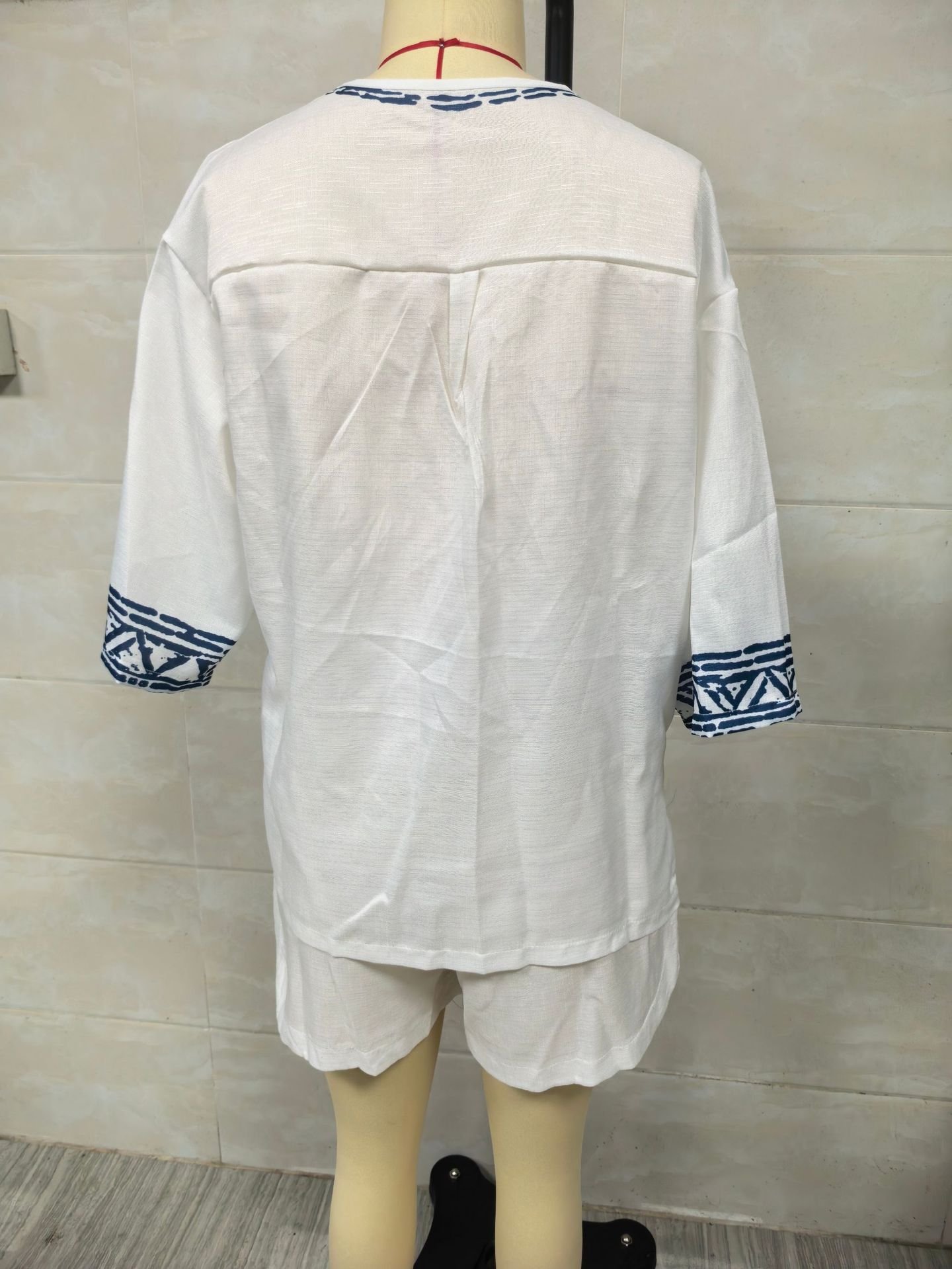 Real photo of the back of the white Bohemian embroidered V-neck linen shorts set