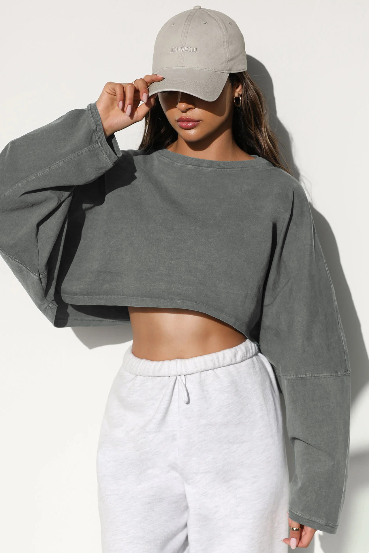 Washed Gray Women's Oversized Cropped Long Sleeve Sweatshirt - Front View Washed gray women's oversized cropped long sleeve sweatshirt, vintage pigment dyed finish, loose fit pullover for loungewear and casual wear, front view on model