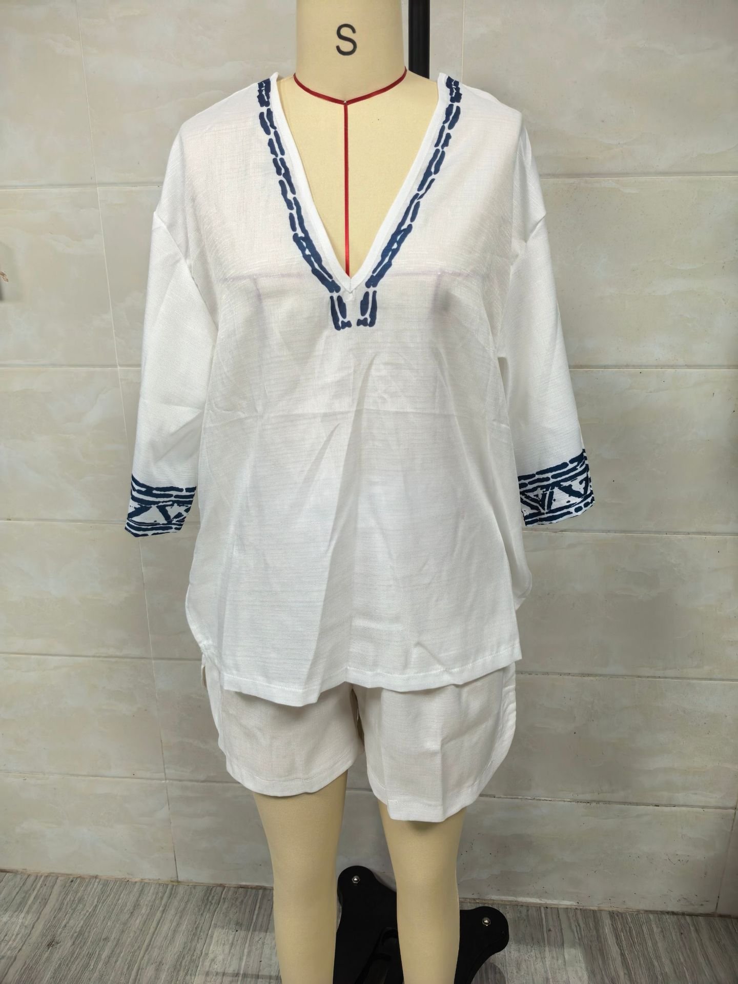 Real photo of the front of the white Bohemian embroidered V-neck linen shorts set